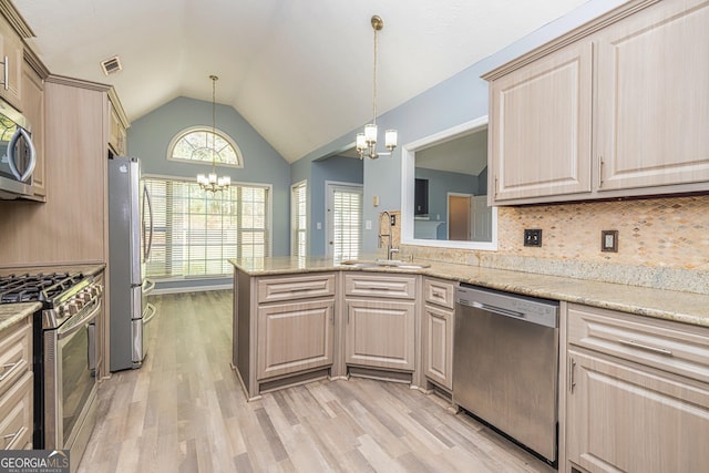 230 Hidden Brook Trl, Fayetteville, GA 30215 - kitchen with a chandelier, stainless steel appliances, a sink, vaulted ceiling, and decorative backsplash