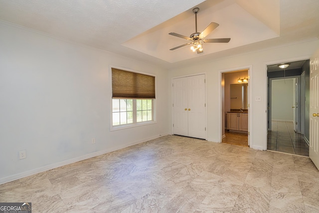 230 Hidden Brook Trl, Fayetteville, GA 30215 - unfurnished bedroom with a raised ceiling, ornamental molding, connected bathroom, baseboards, and ceiling fan