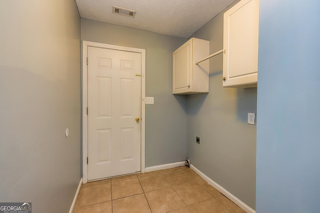 230 Hidden Brook Trl, Fayetteville, GA 30215 - washroom featuring hookup for an electric dryer, cabinet space, baseboards, light tile patterned flooring, and a textured ceiling