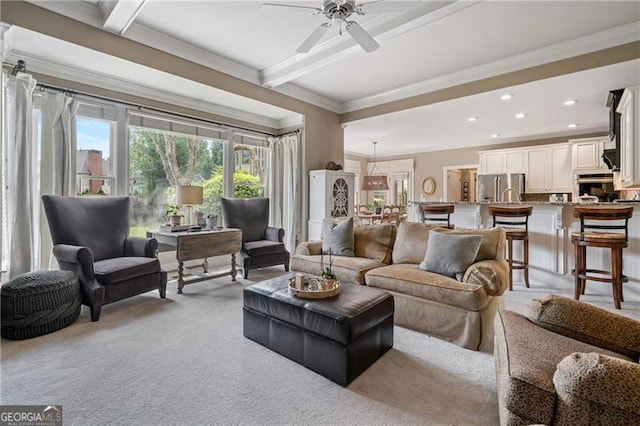 295 Sagamore Cv NW, Sugar Hill, GA 30518 - living area with healthy amount of natural light, ceiling fan, crown molding, beamed ceiling, and light carpet