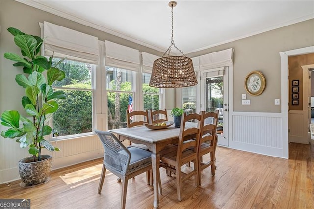 295 Sagamore Cv NW, Sugar Hill, GA 30518 - dining space featuring ornamental molding, light wood-style flooring, and a wainscoted wall