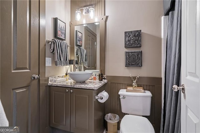 295 Sagamore Cv NW, Sugar Hill, GA 30518 - full bathroom with wainscoting, vanity, and toilet