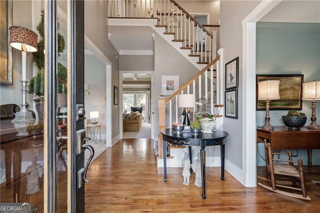 295 Sagamore Cv NW, Sugar Hill, GA 30518 - foyer entrance with wood finished floors, crown molding, stairway, and baseboards