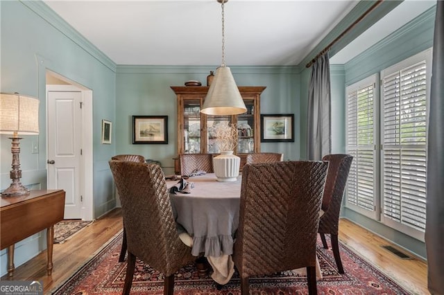 295 Sagamore Cv NW, Sugar Hill, GA 30518 - dining room featuring wood finished floors and ornamental molding