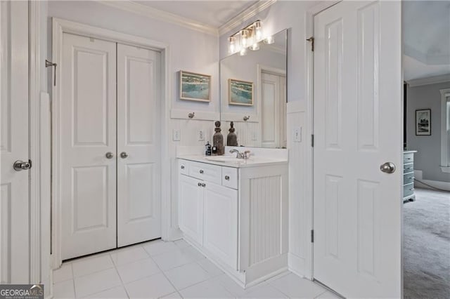 bathroom featuring crown molding, vanity, and tile patterned floors