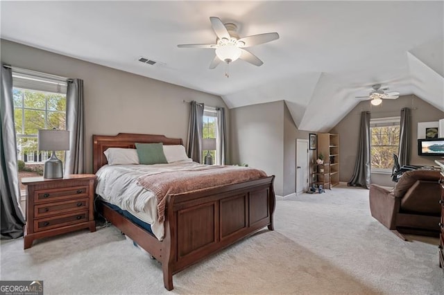 bedroom featuring multiple windows, lofted ceiling, light carpet, and ceiling fan