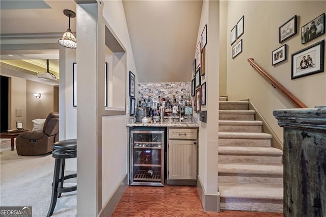295 Sagamore Cv NW, Sugar Hill, GA 30518 - indoor wet bar featuring wine cooler, stairway, and wood finished floors