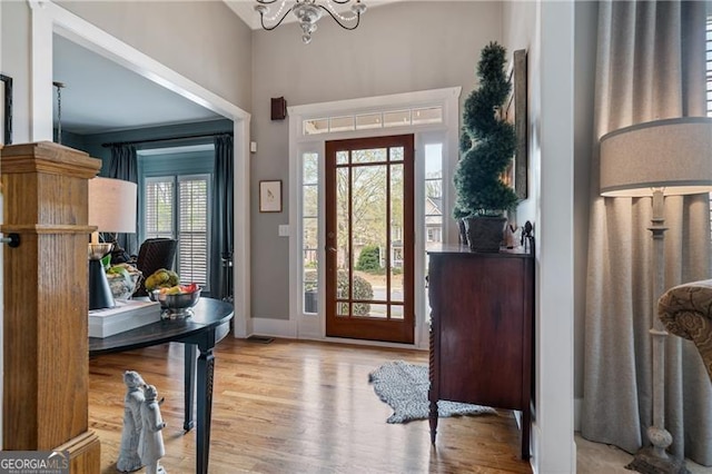 295 Sagamore Cv NW, Sugar Hill, GA 30518 - entrance foyer featuring wood finished floors, a chandelier, and baseboards
