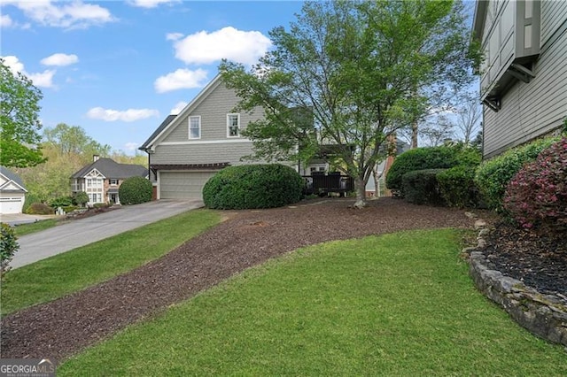 view of front of home with a garage, driveway, and a front yard