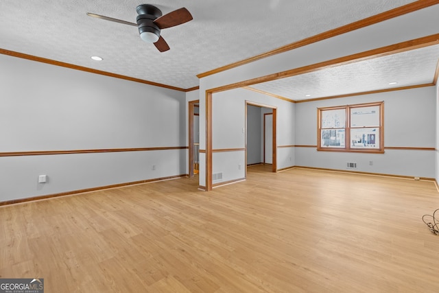 empty room with visible vents, ceiling fan, light wood-type flooring, and a textured ceiling