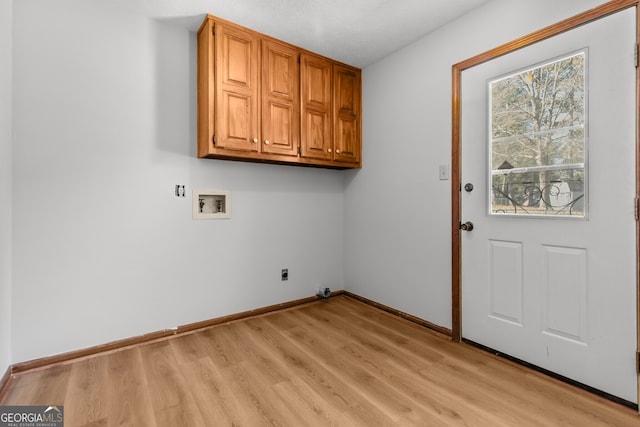 laundry room with cabinet space, baseboards, light wood finished floors, and washer hookup