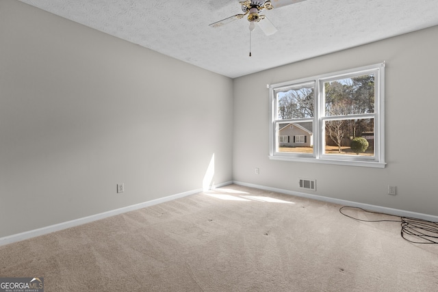 unfurnished room with visible vents, baseboards, ceiling fan, a textured ceiling, and carpet flooring