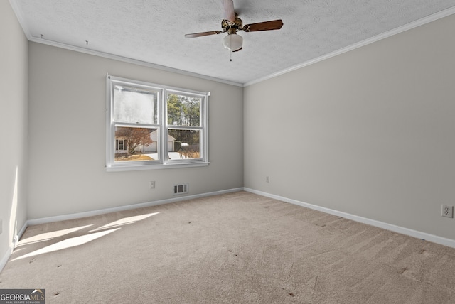 unfurnished room with ceiling fan, a textured ceiling, ornamental molding, visible vents, and carpet floors
