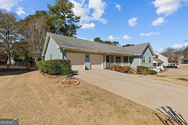 single story home featuring a porch, a garage, fence, and driveway