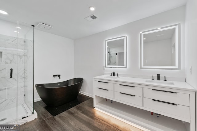 bathroom featuring a sink, visible vents, and a marble finish shower