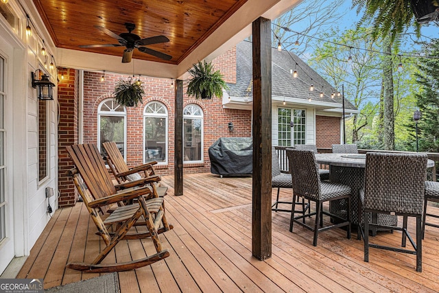 wooden terrace with a ceiling fan