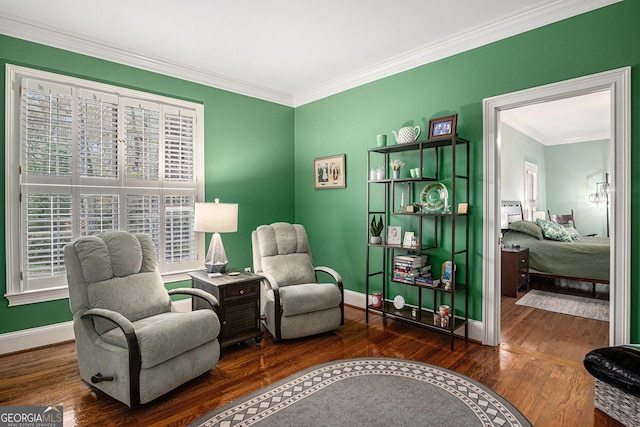 living area featuring wood finished floors, crown molding, and baseboards