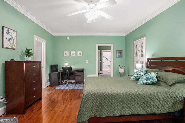 bedroom featuring baseboards, a ceiling fan, wood finished floors, and crown molding
