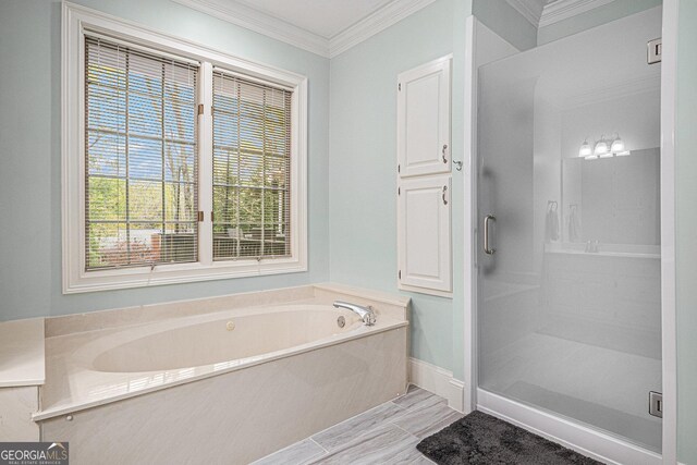 bathroom featuring a bath, baseboards, ornamental molding, and a stall shower