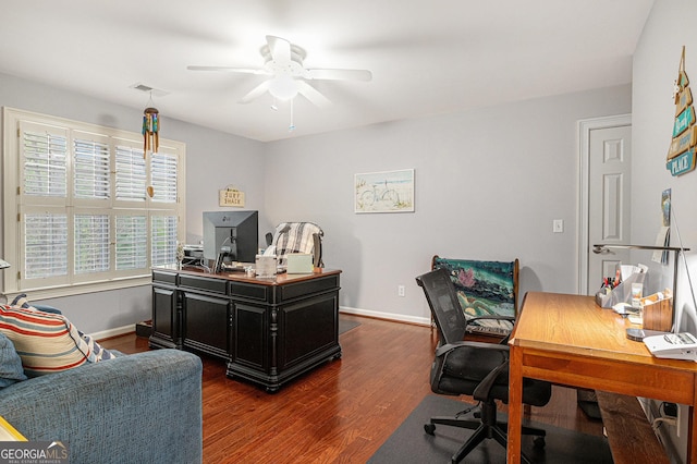 office area with baseboards, a ceiling fan, visible vents, and dark wood finished floors
