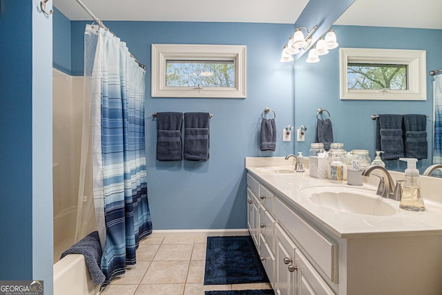 full bathroom with tile patterned flooring, a sink, and a healthy amount of sunlight