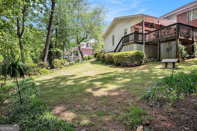 view of yard with a wooden deck and stairway