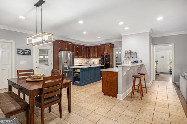 kitchen featuring stainless steel fridge with ice dispenser, light countertops, ornamental molding, a peninsula, and tasteful backsplash