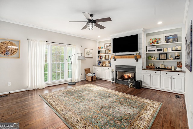105 Blackberry Ct, Woodstock, GA 30188 - living room with a fireplace, a ceiling fan, ornamental molding, dark wood-style floors, and built in shelves