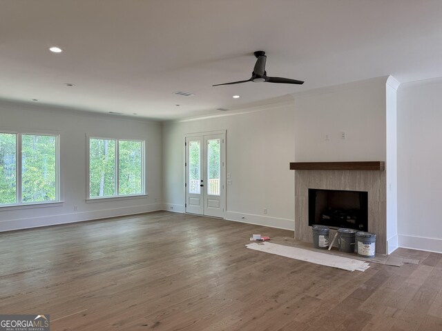 empty room featuring baseboards, a healthy amount of sunlight, and light wood-style floors