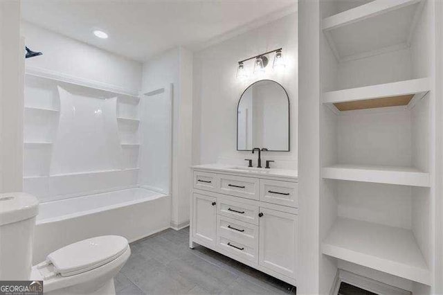 full bath with  shower combination, vanity, toilet, and wood finished floors
