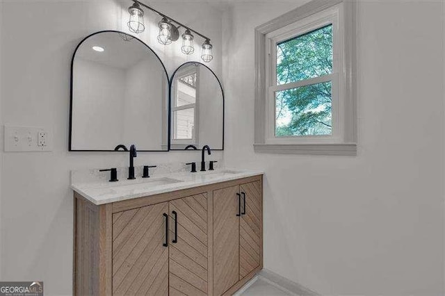 bathroom with a sink and double vanity