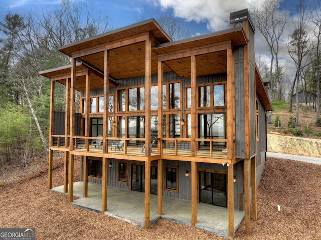 768 Cherokee Cir, Ellijay, GA 30540 - back of property featuring a patio area, board and batten siding, a chimney, and a wooden deck