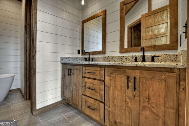 768 Cherokee Cir, Ellijay, GA 30540 - bathroom with a sink, wood walls, double vanity, and a soaking tub