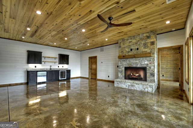 768 Cherokee Cir, Ellijay, GA 30540 - unfurnished living room with ceiling fan, a fireplace, wine cooler, wood ceiling, and recessed lighting