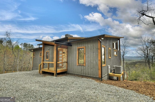 768 Cherokee Cir, Ellijay, GA 30540 - exterior space featuring board and batten siding, a chimney, driveway, and central AC