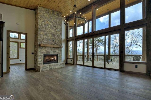 768 Cherokee Cir, Ellijay, GA 30540 - unfurnished living room with baseboards, a chandelier, a fireplace, hardwood / wood-style flooring, and wooden ceiling