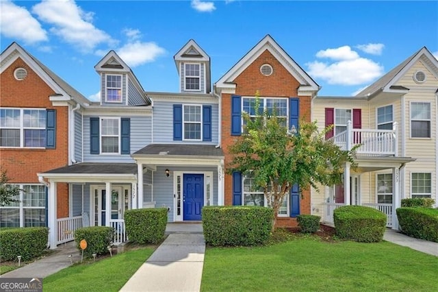 1575 April Ln, Morrow, GA 30260 - townhome / multi-family property with a porch, a front yard, and brick siding