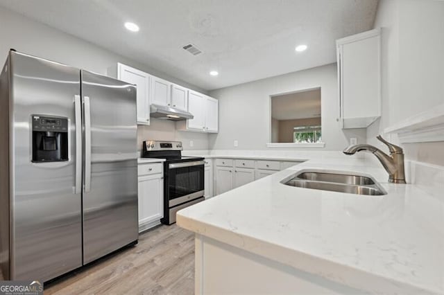 1575 April Ln, Morrow, GA 30260 - kitchen featuring visible vents, a sink, light wood-style floors, under cabinet range hood, and stainless steel appliances