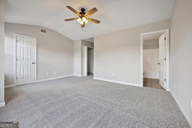 1575 April Ln, Morrow, GA 30260 - unfurnished bedroom featuring lofted ceiling, baseboards, carpet flooring, visible vents, and ceiling fan