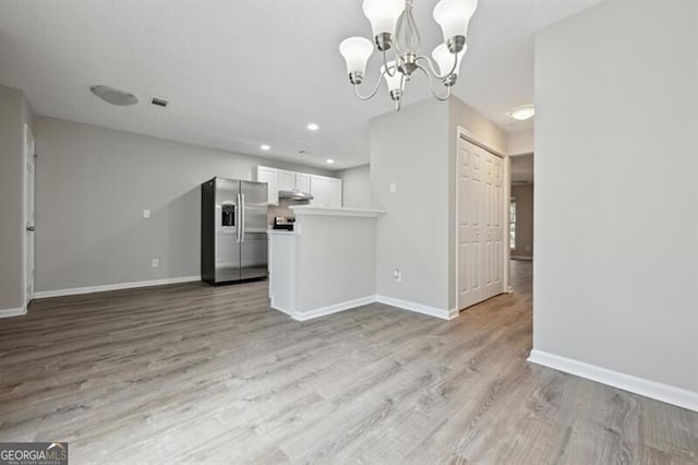 1575 April Ln, Morrow, GA 30260 - kitchen featuring baseboards, stainless steel refrigerator with ice dispenser, a chandelier, and light wood-style floors