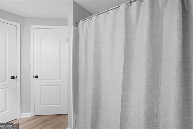 4307 Orchard Park Ct Unit A, Stone Mountain, GA 30083 - full bathroom with wood finished floors and a textured ceiling