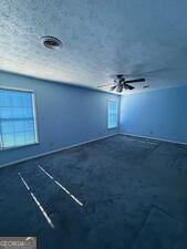 4528 Newcastle Cir, Lithonia, GA 30038 - unfurnished room with ceiling fan and a textured ceiling