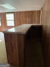 4528 Newcastle Cir, Lithonia, GA 30038 - bar with wood walls and a drop ceiling