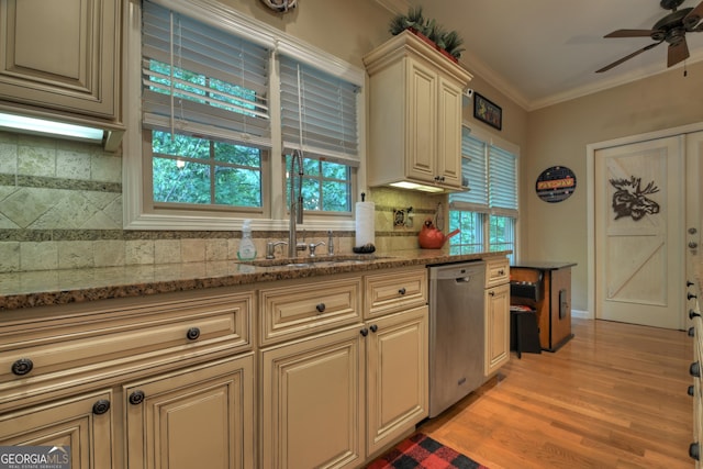 kitchen featuring ceiling fan, stainless steel dishwasher, ornamental molding, cream cabinetry, and a sink