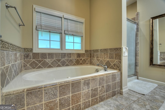 full bath featuring a bath and a stall shower