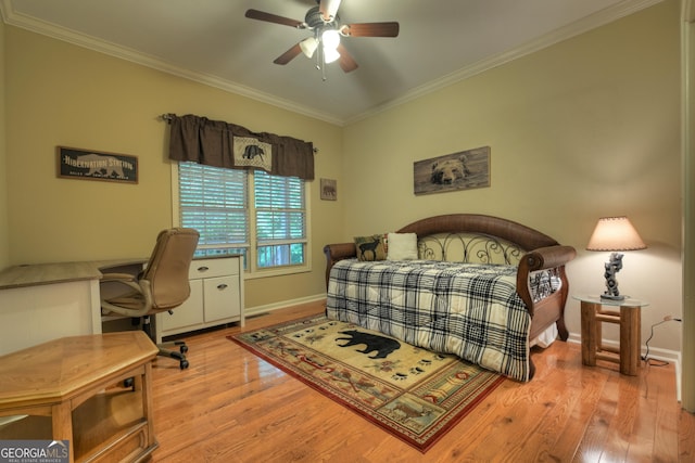 bedroom featuring light wood-style flooring, baseboards, and ornamental molding