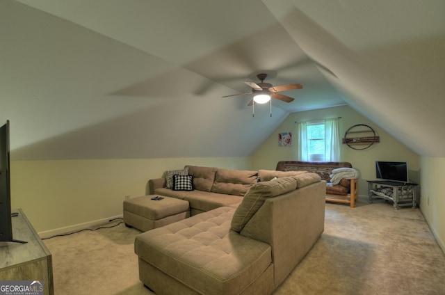 living room featuring light colored carpet, baseboards, a ceiling fan, and vaulted ceiling