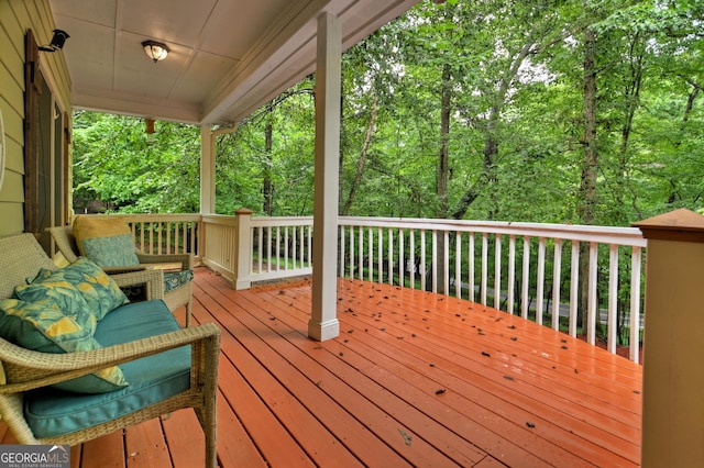 wooden terrace featuring a forest view