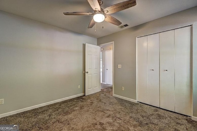 unfurnished bedroom with visible vents, baseboards, a closet, and carpet floors