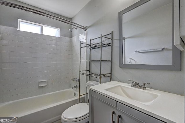 bathroom with vanity, bathtub / shower combination, and toilet